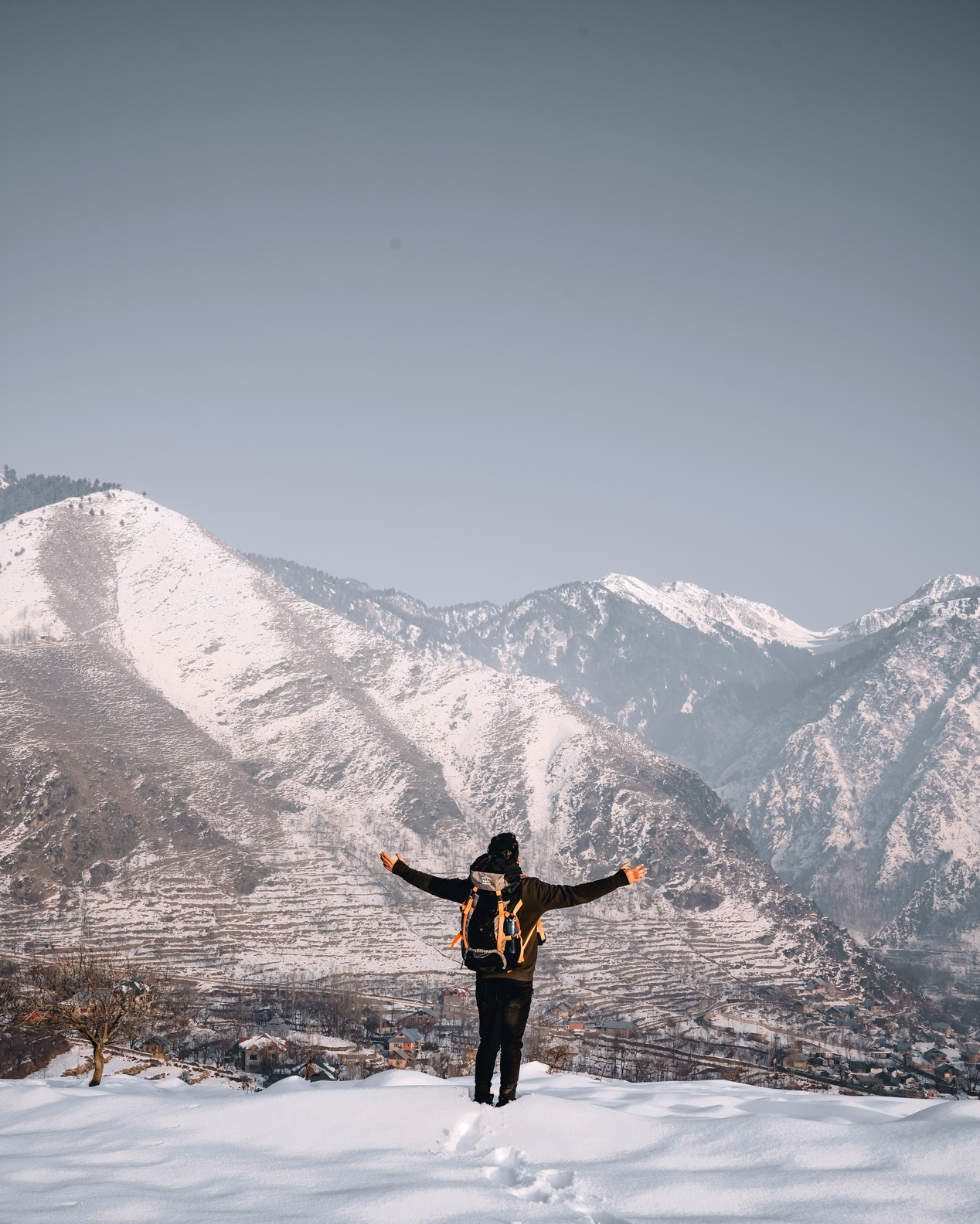 Back View of a Person Standing on Snowy Ground